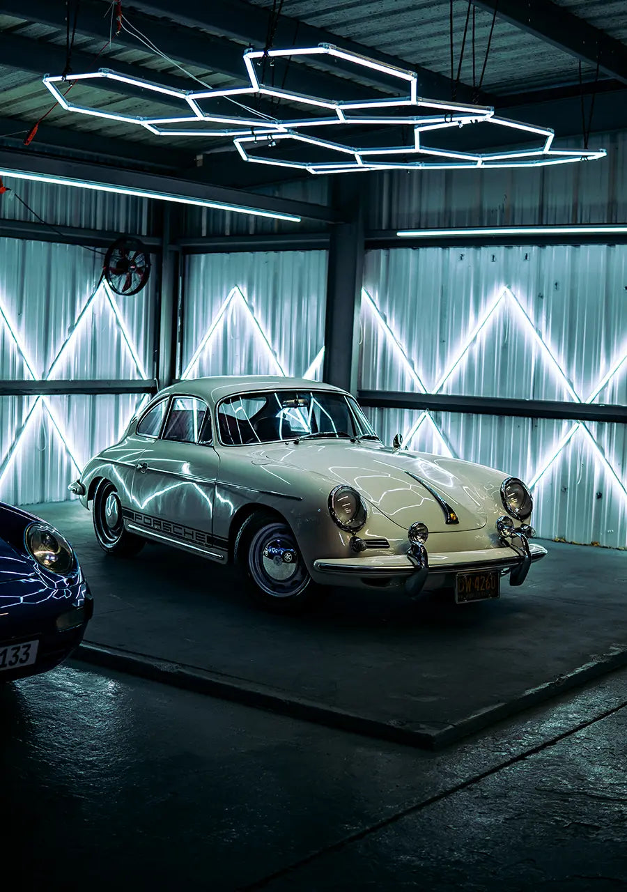 A classic white Porsche featured in the display corner of the Superior Autohaus garage.