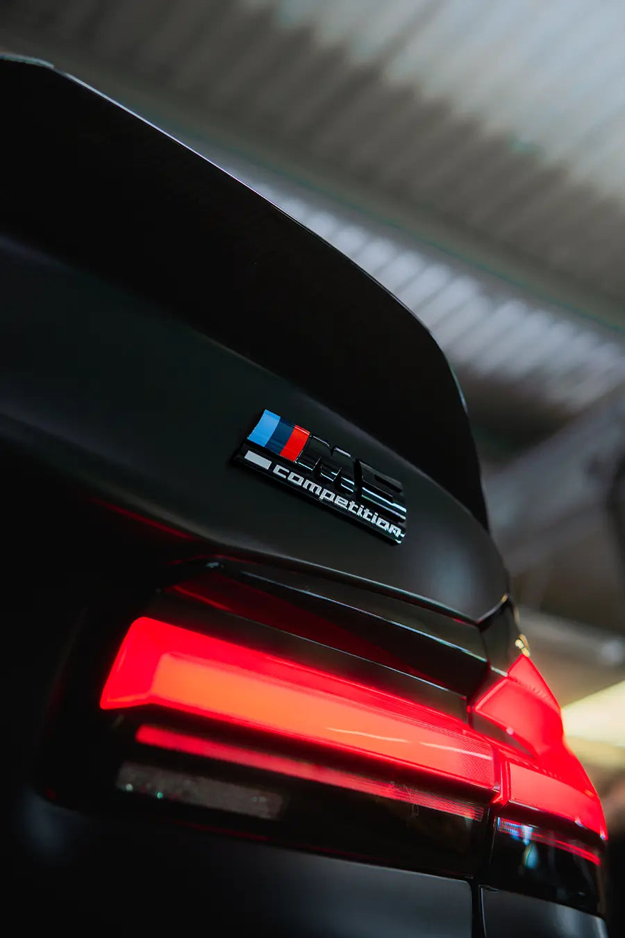 Detail of the taillight of an M5 Competition BMW car.