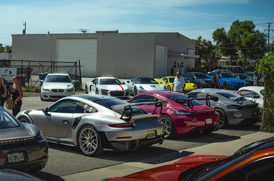 Sports cars lined up on the street outside the Superior Autohaus garage in Bonita Springs, Florida. Car enthusiasts celebrate and admire each other's customized rides.