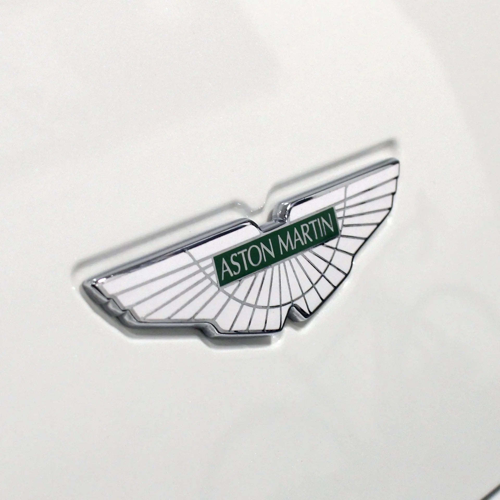 Aston Martin badge on a white car. 