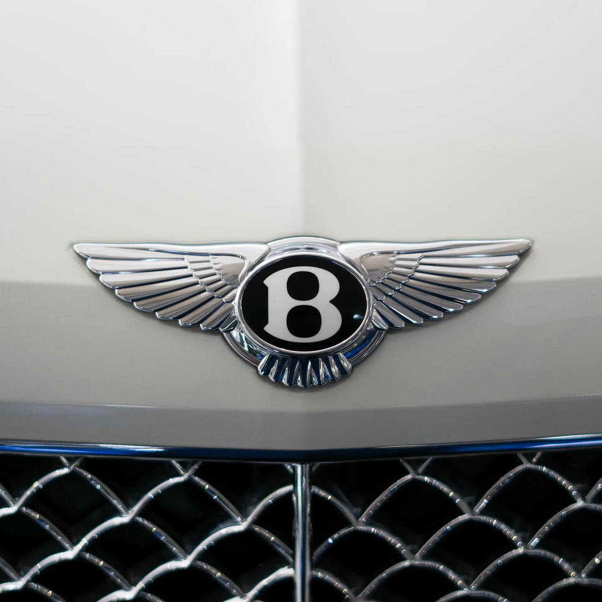 Bentley badge on a white car. 
