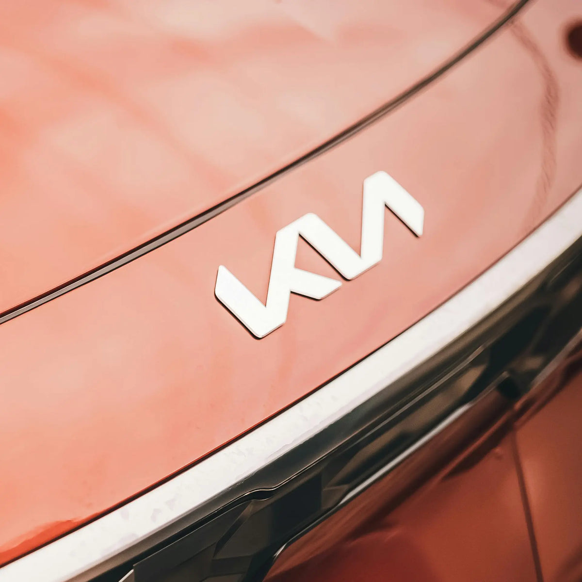 Kia badge on an orange car. 