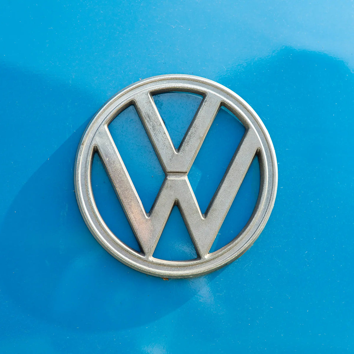 Volkswagen badge on a blue car. 