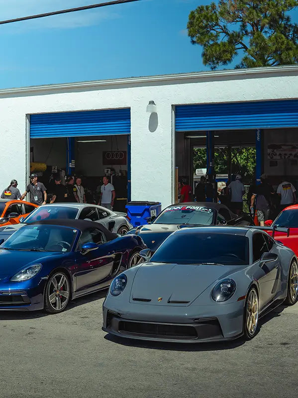 Sports cars lined up in front of the Superior Autohaus garage. 